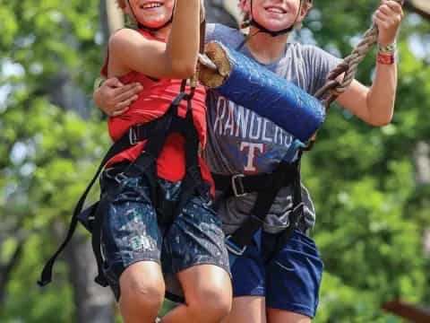 a person and a boy on a zip line