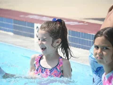 a couple of girls in a pool