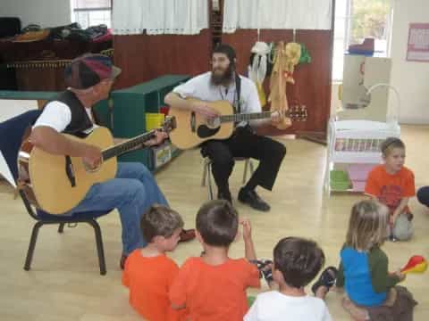 a group of people playing guitars