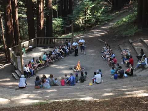 a group of people sitting on the ground in a park