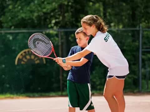 a couple of people play tennis