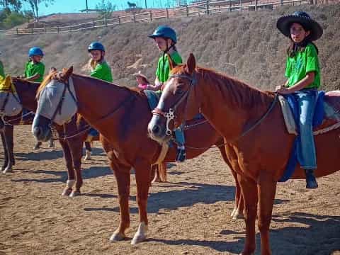 a group of people riding horses