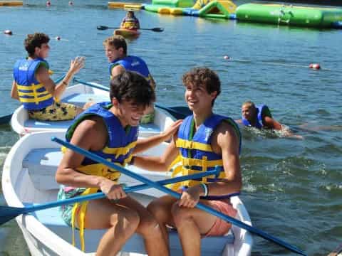 a group of people rowing a boat