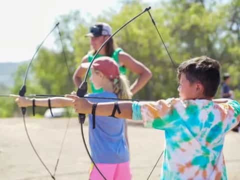 a group of people shooting bows