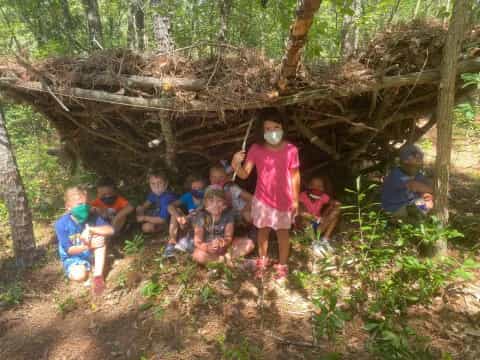 a group of kids in a wooded area