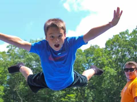 a boy jumping in the air