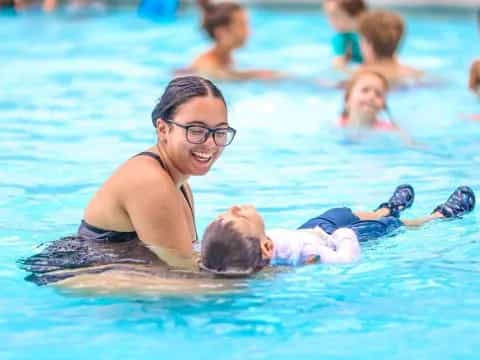 a man and a baby in a pool