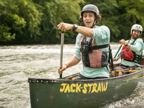 a couple of men in a canoe
