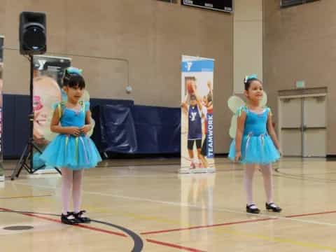 a couple of girls in blue dresses