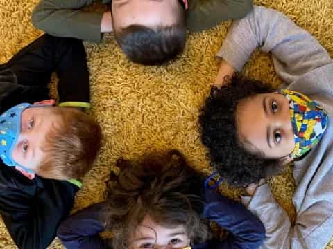 a group of people lying on the ground posing for the camera