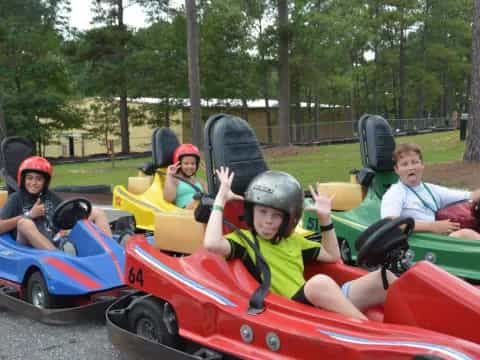 a group of kids in a go-kart