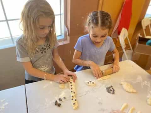 a couple of young girls making a mess