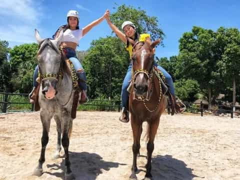 a group of people riding horses