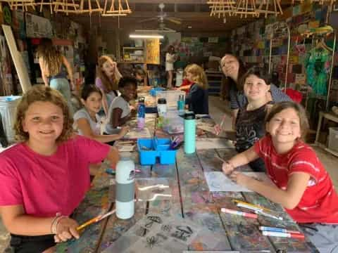 a group of children sitting at a table