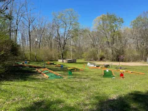 a grassy area with trees in the background