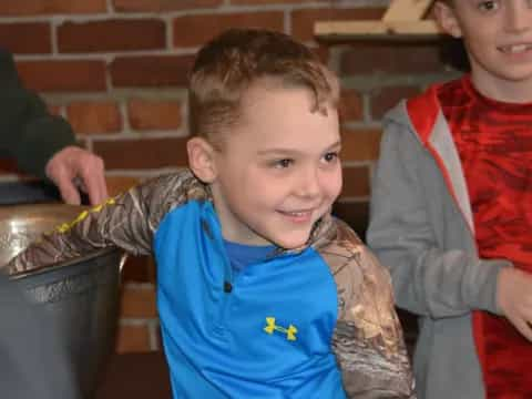 a boy holding a bucket