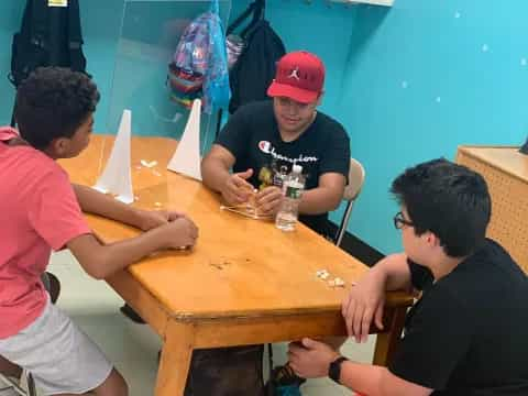 a group of men sitting around a table playing a board game