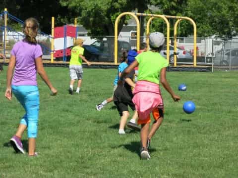 a group of kids playing football