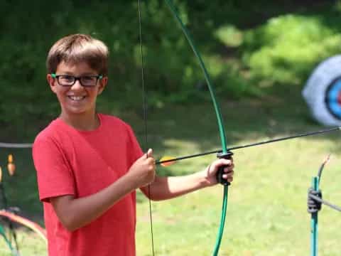 a boy holding a bow and arrow
