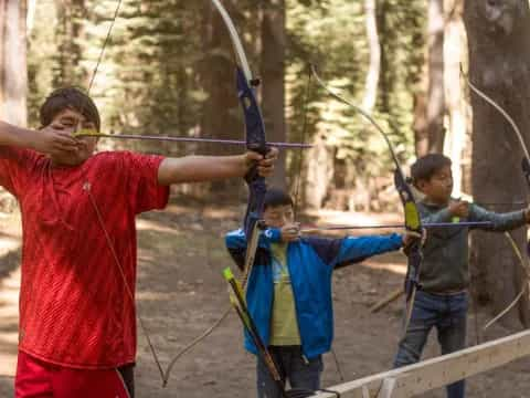 a group of people holding bows and arrows