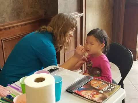 a woman and a child painting