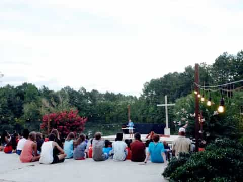 a group of people sitting on a bench in front of a park