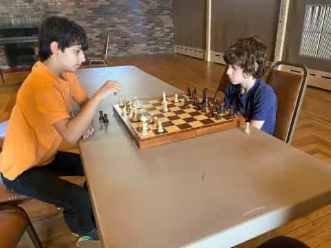 a couple of boys playing chess