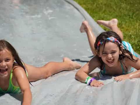 two girls lying on a blanket