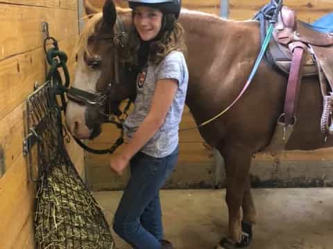 a person standing next to a horse