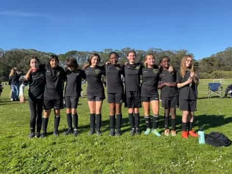 a group of girls in black uniforms