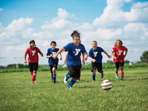 a group of kids playing football