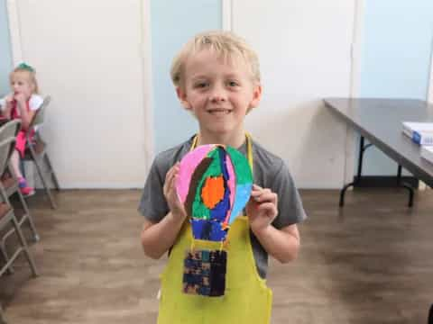 a boy holding a toy