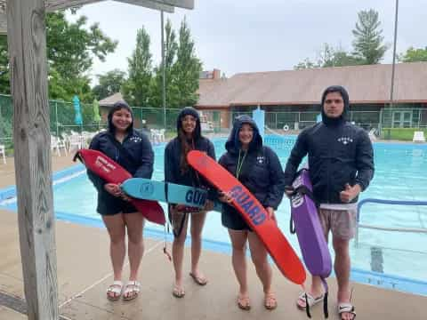 a group of women holding surfboards