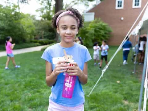 a girl holding a toy