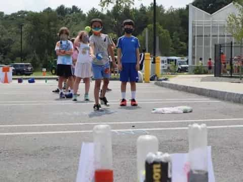 a group of people wearing numbers and running on a street