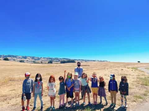 a group of people standing in a field