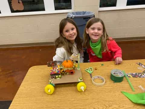 two girls sitting at a table