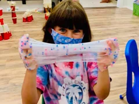 a young girl holding a plastic bag