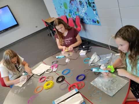 a few young girls working on a project