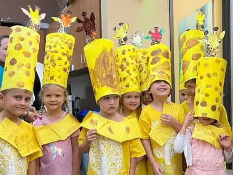 a group of children wearing yellow and red clothing