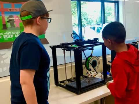 a couple of boys looking at a computer