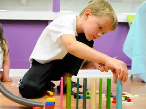 a young boy playing with toys