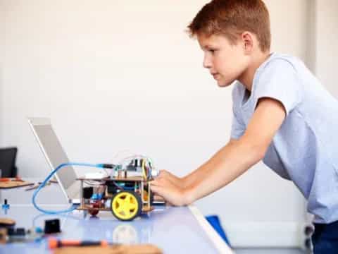 a young boy working on a toy car