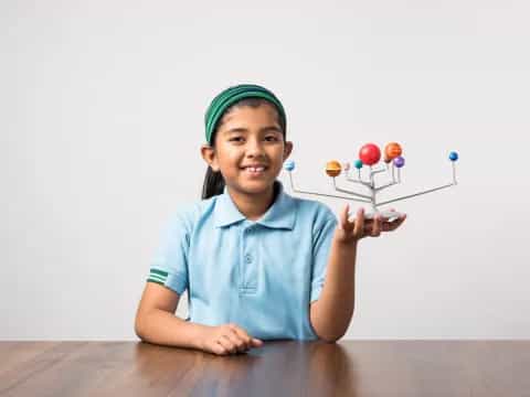 a young girl holding a balloon