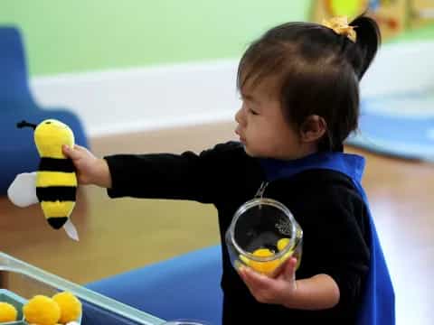 a child holding a yellow duck
