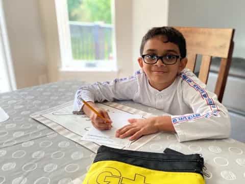a boy sitting at a table