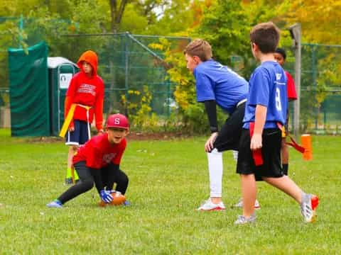 a group of kids playing football