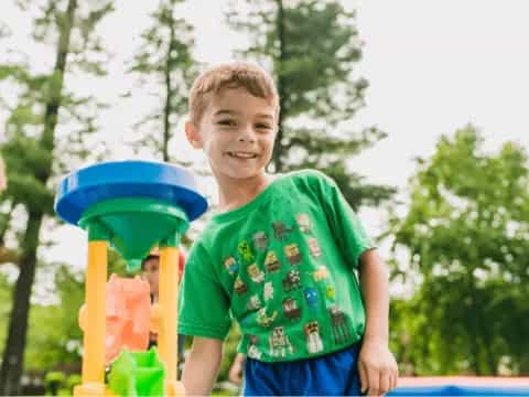 a boy playing with a frisbee