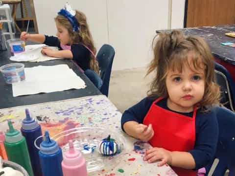 a girl sitting at a table