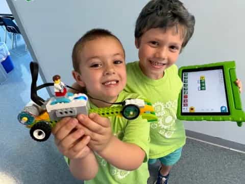 a couple of boys holding a toy